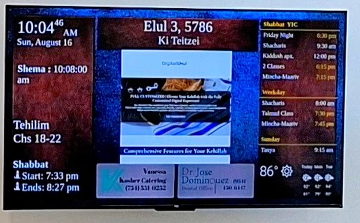 Close-up of a DigitalShul zmanim display: atomic clock, Shema time, Tehilim chapters, Shabbat start and end, weekly schedule and community advertising